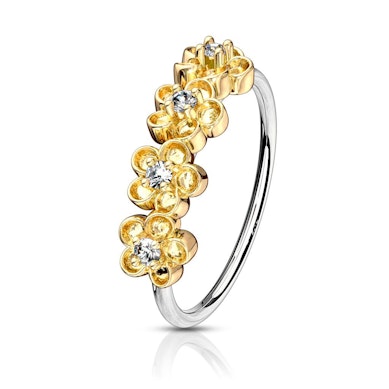 Ring med fyra blommor på sidan dekorerad med stenar