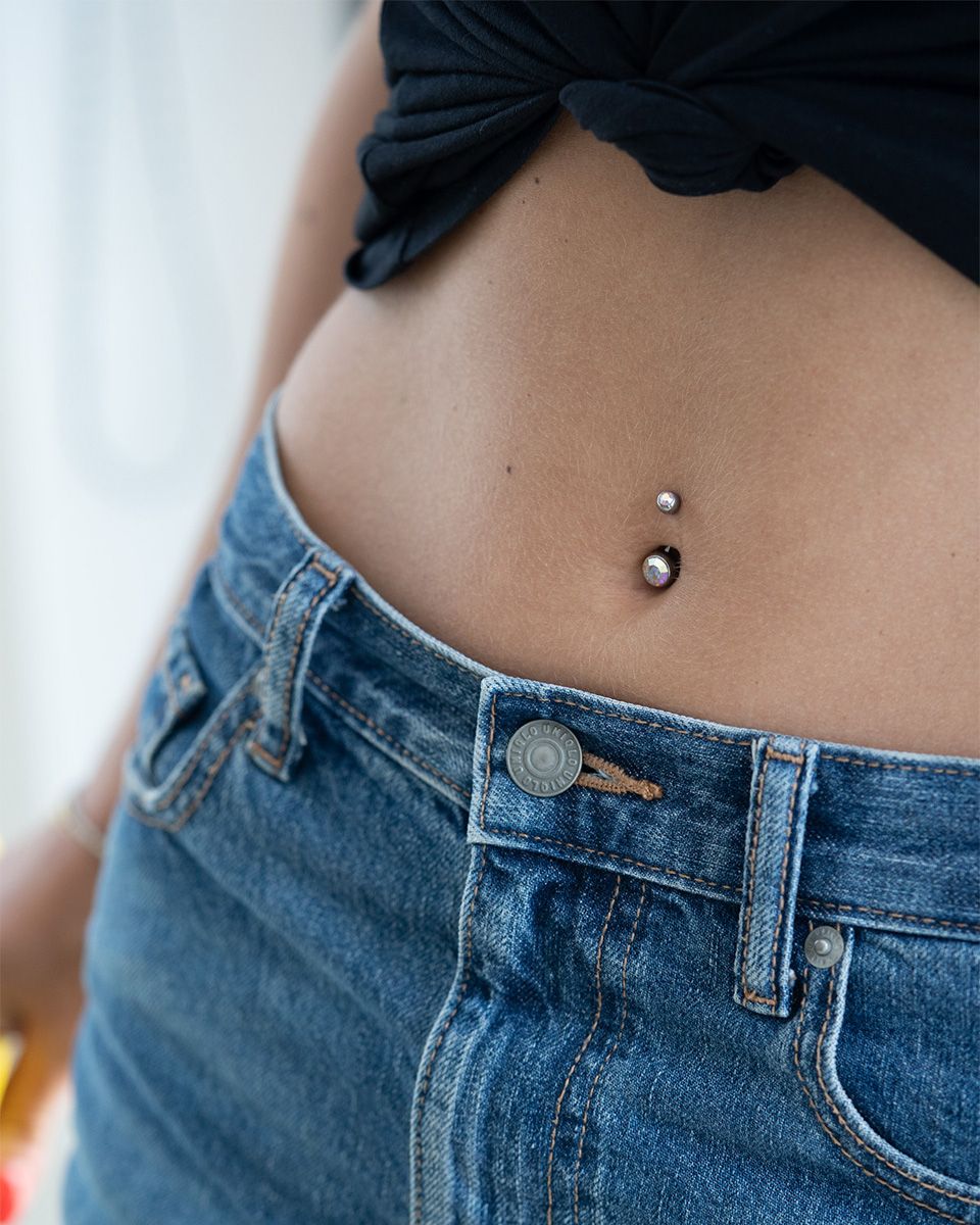 Navelpiercing av titan med två stenar