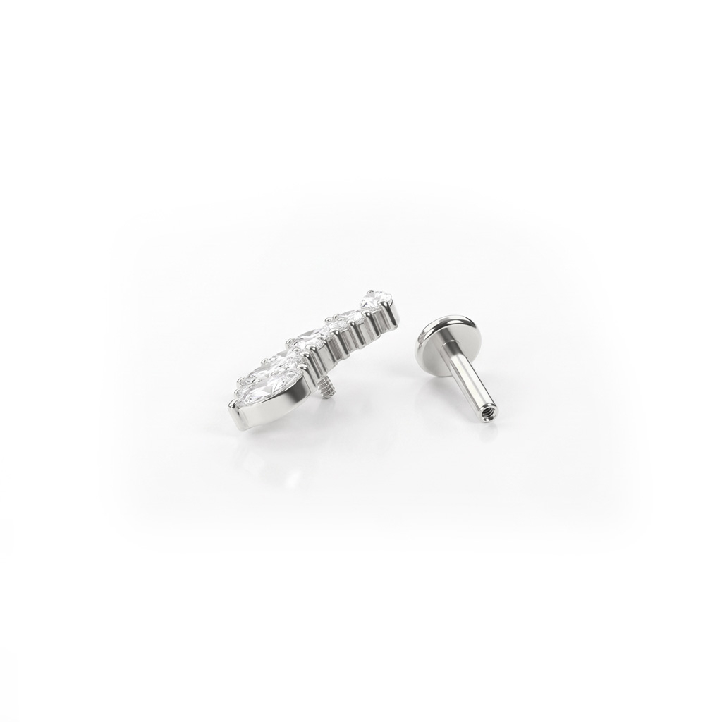 Labret i titan med marquise-stenar och runda stenar