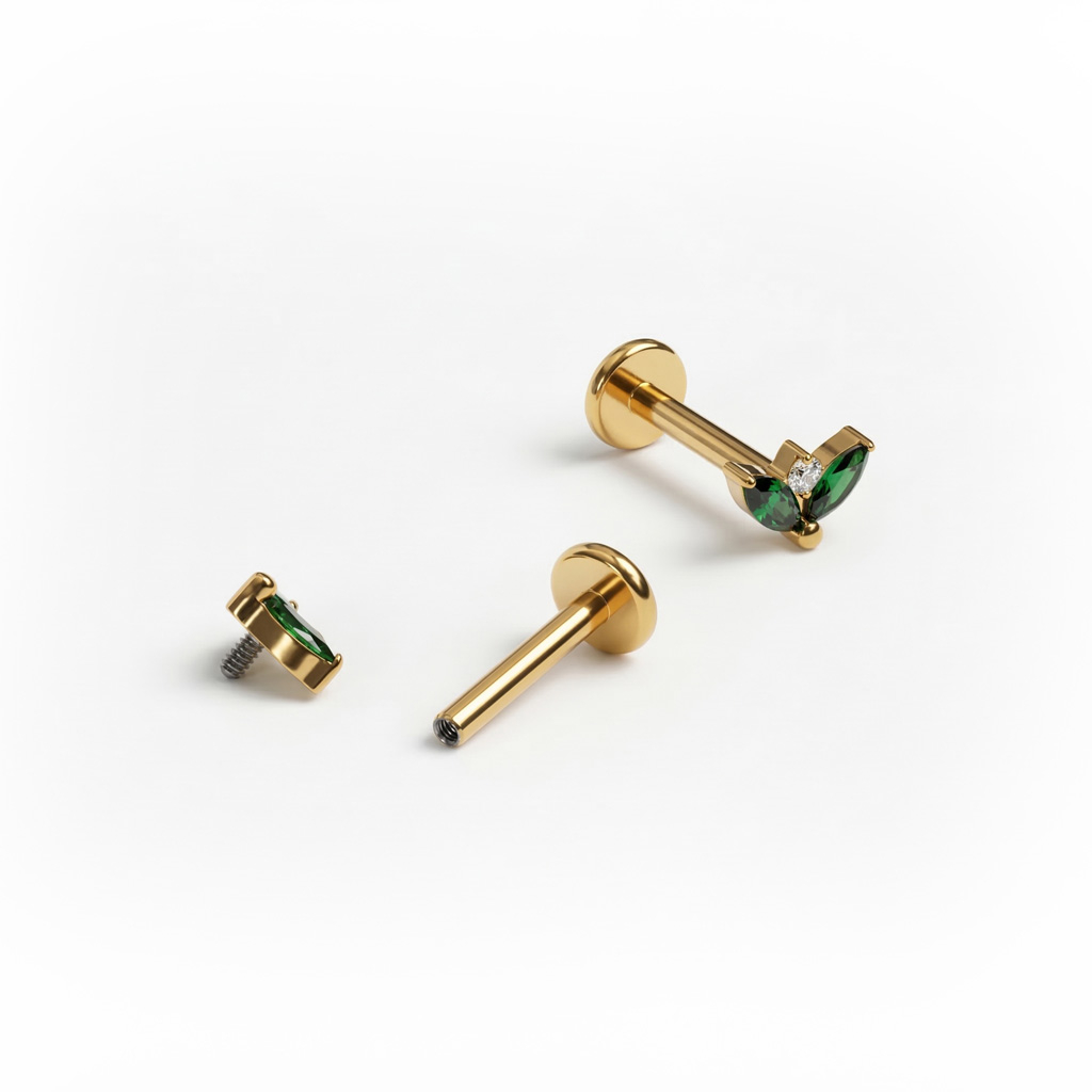 Titanlabret med par av smaragdfärgade stenar